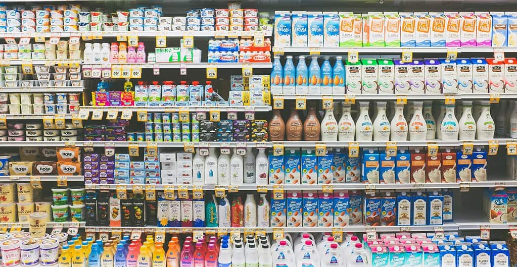 Supermarket shelf stocked with almond milk products
