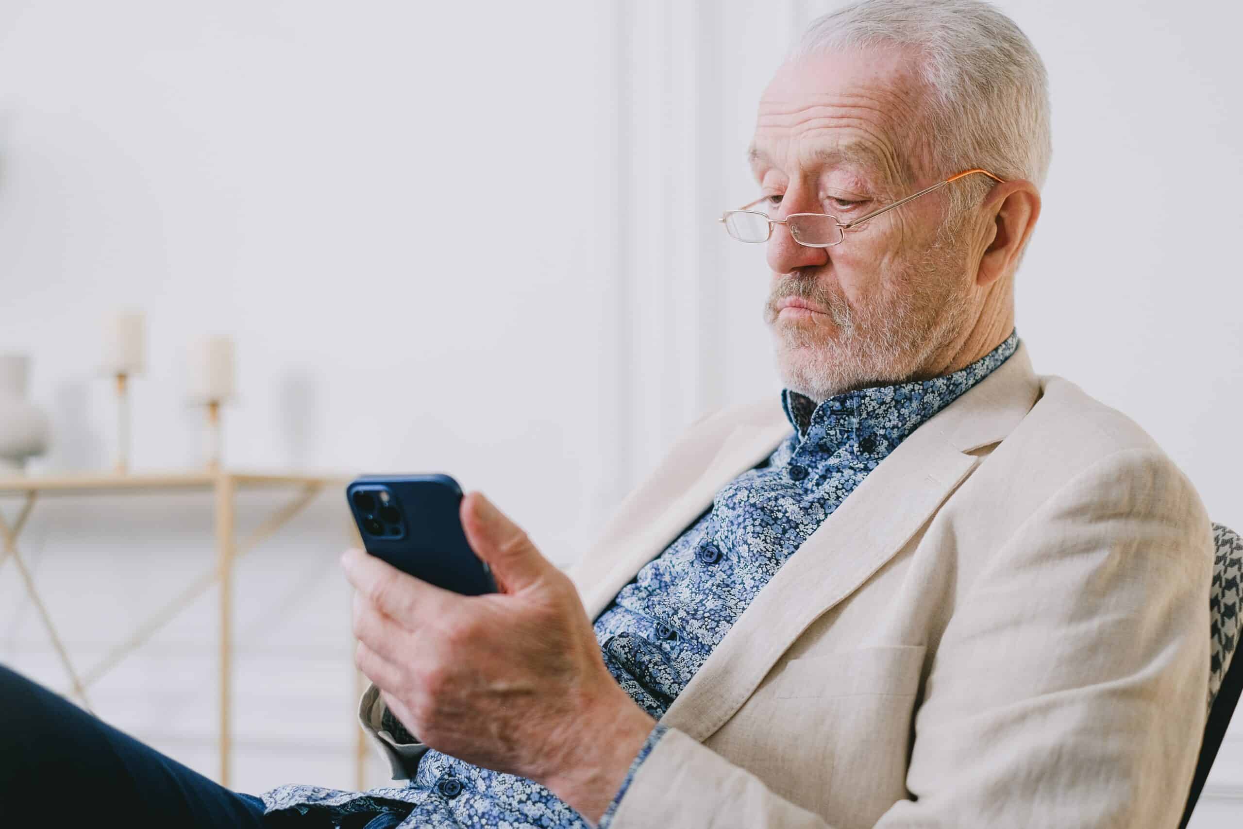 old person browsing smartphone