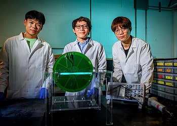 Professor Yi-Cheng Wang, center is joined by first author Zhenhui Jin, left, and Longwen Li in the labs of the Agricultural Engineering Sciences Building. Together, they developed a Tribo-sanitizer, which uses a freestanding rotational triboelectric nanogenerator (FSR-TENG) to convert mechanical energy into sustainable, low-cost or free electricity that powers an ultraviolet-C (UVC) lamp for food-safety applications. The project was done at the University of Illinois Urbana-Champaign.