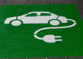 A sign indicating parking space with EV charging facility.