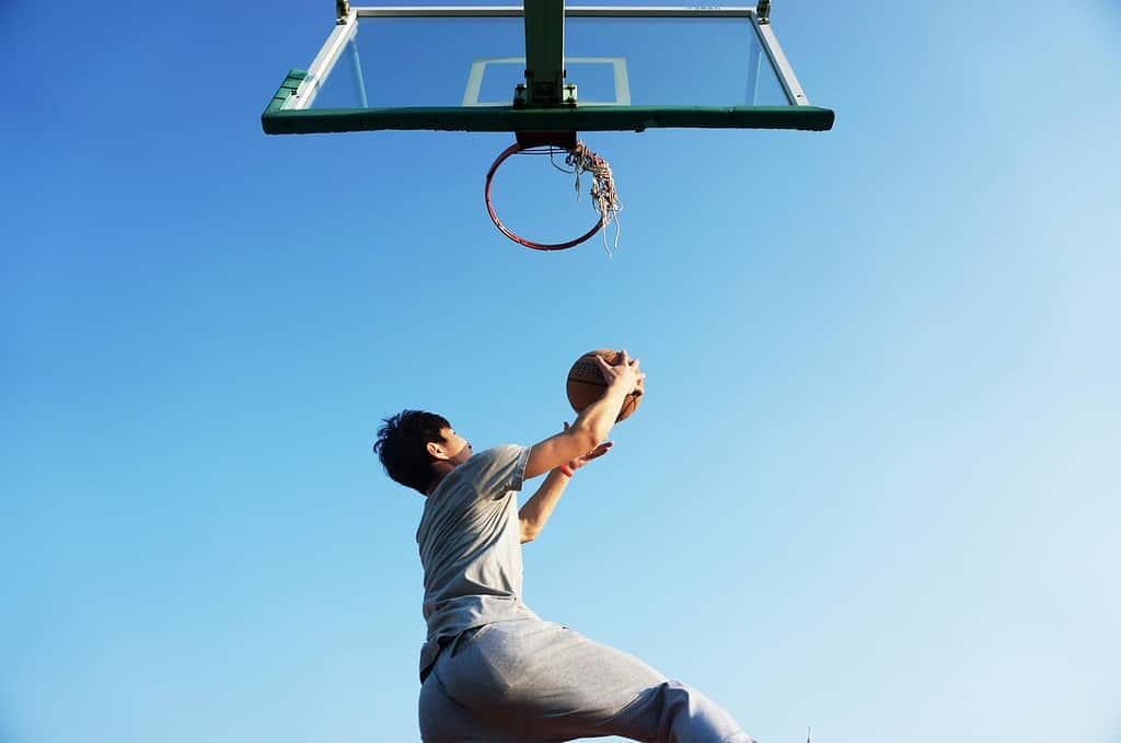 Someone playing basketball near a hoop