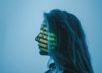 A girl with projection of digital number codes on her face