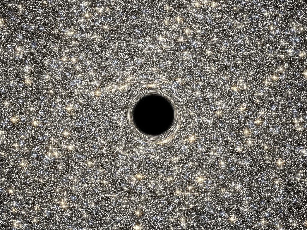 This is an illustration of a supermassive black hole, weighing as much as 21 million suns, located in the middle of the ultradense galaxy M60-UCD1.