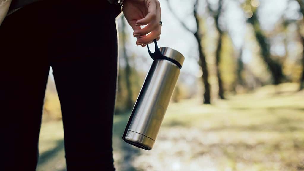 Person holding reusable water bottle