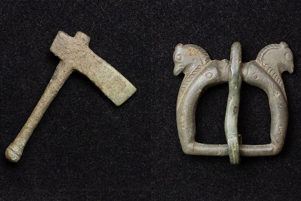 A miniature votive axe and the horse-headed buckle. 